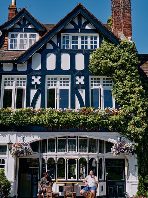 people enjoying the sun outside the Greyhound pub