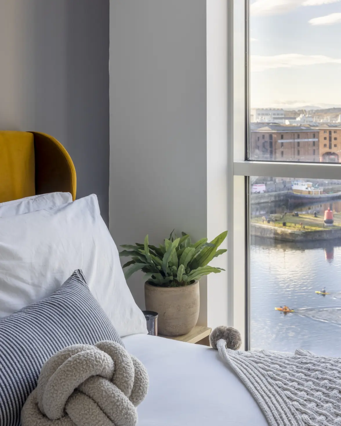 a double bed with a window overlooking Albert Dock