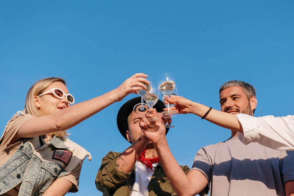 young people clinking glasses 'cheers'