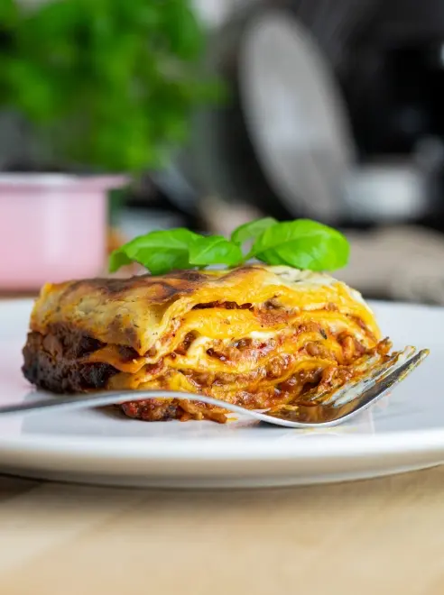plate of lasagne with fork beside