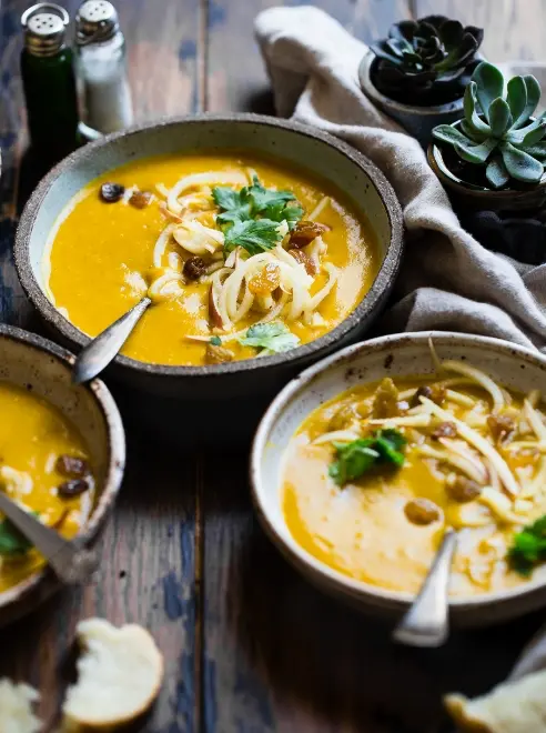 three plates of food, a salt and pepper shakers and napkin on a table