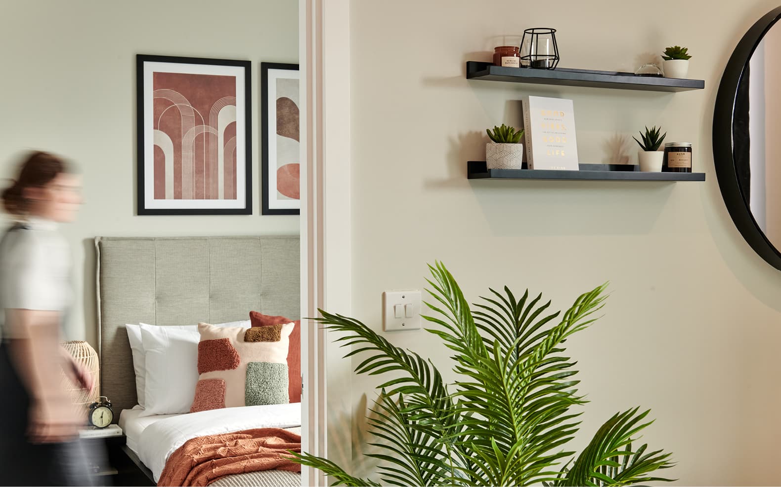lounge shelves, pot plant, view into bedroom of girl walking through
