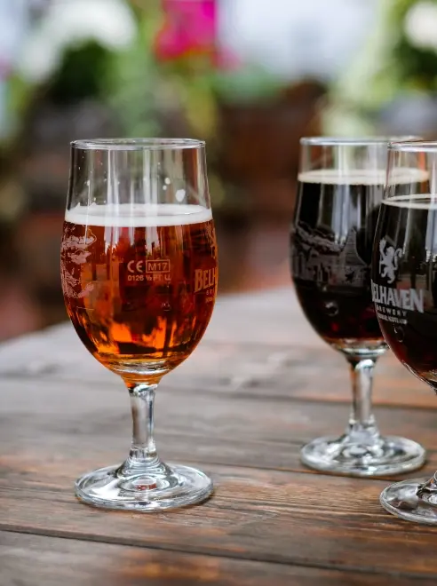three glasses of beer on an outside table