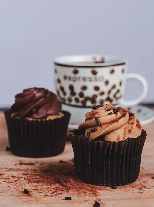 two cupcakes and a cup and saucer