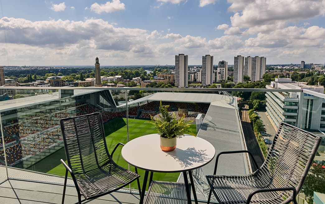 sunny roof terrace with table and chairs