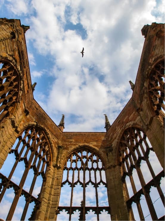looking up to the sky looking at top of burned out church