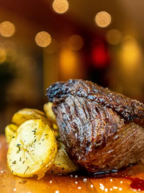 roasted potatoes with a steak resting on top