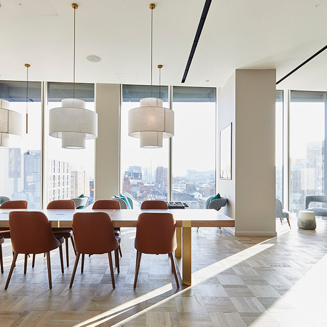 person in kitchen with table set for 2