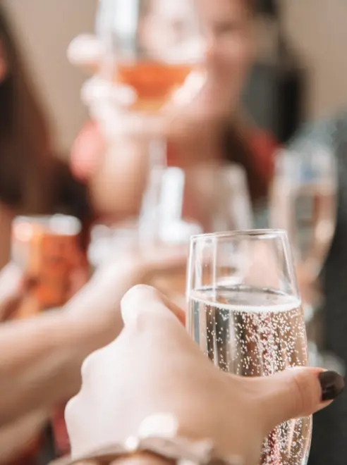 person holding a glass of bubbly